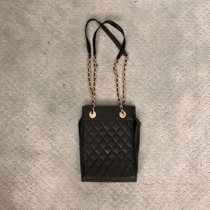Black purse with gold chain straps